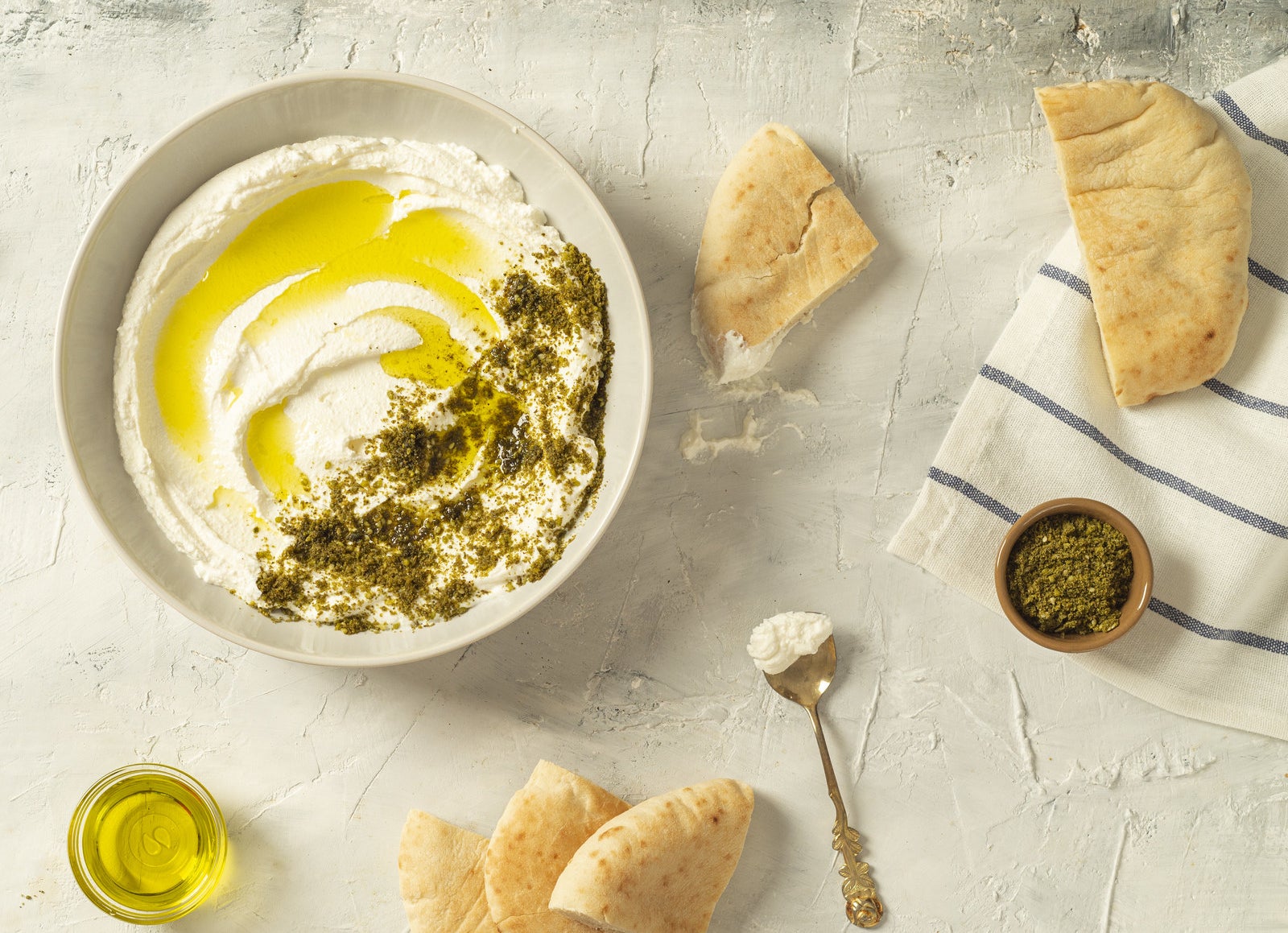 Hummus dip topped with za&#x27;atar spice blend and olive oil.