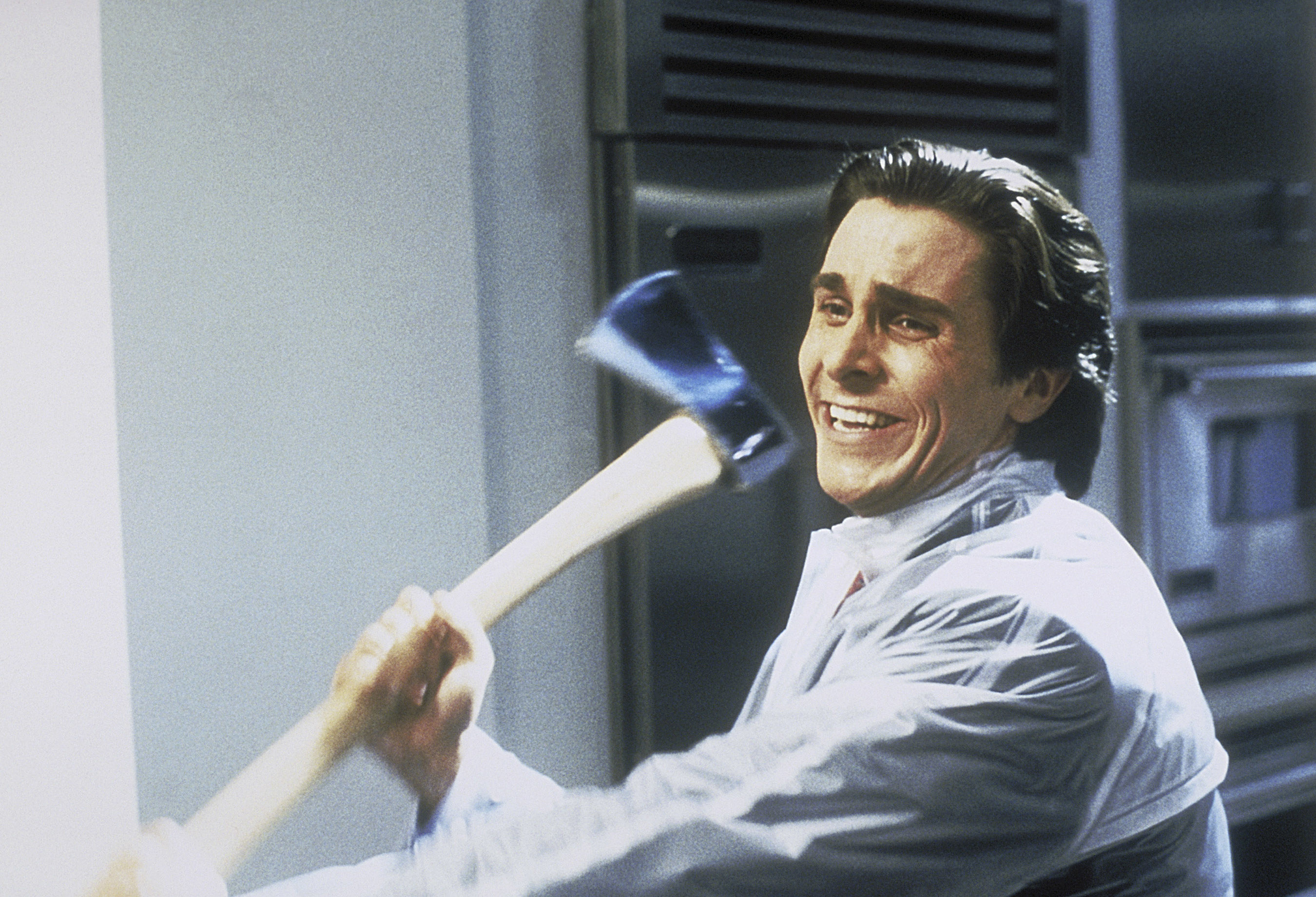Christian Bale attacks someone with an axe