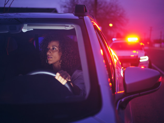 A woman being pulled over by a police officer.