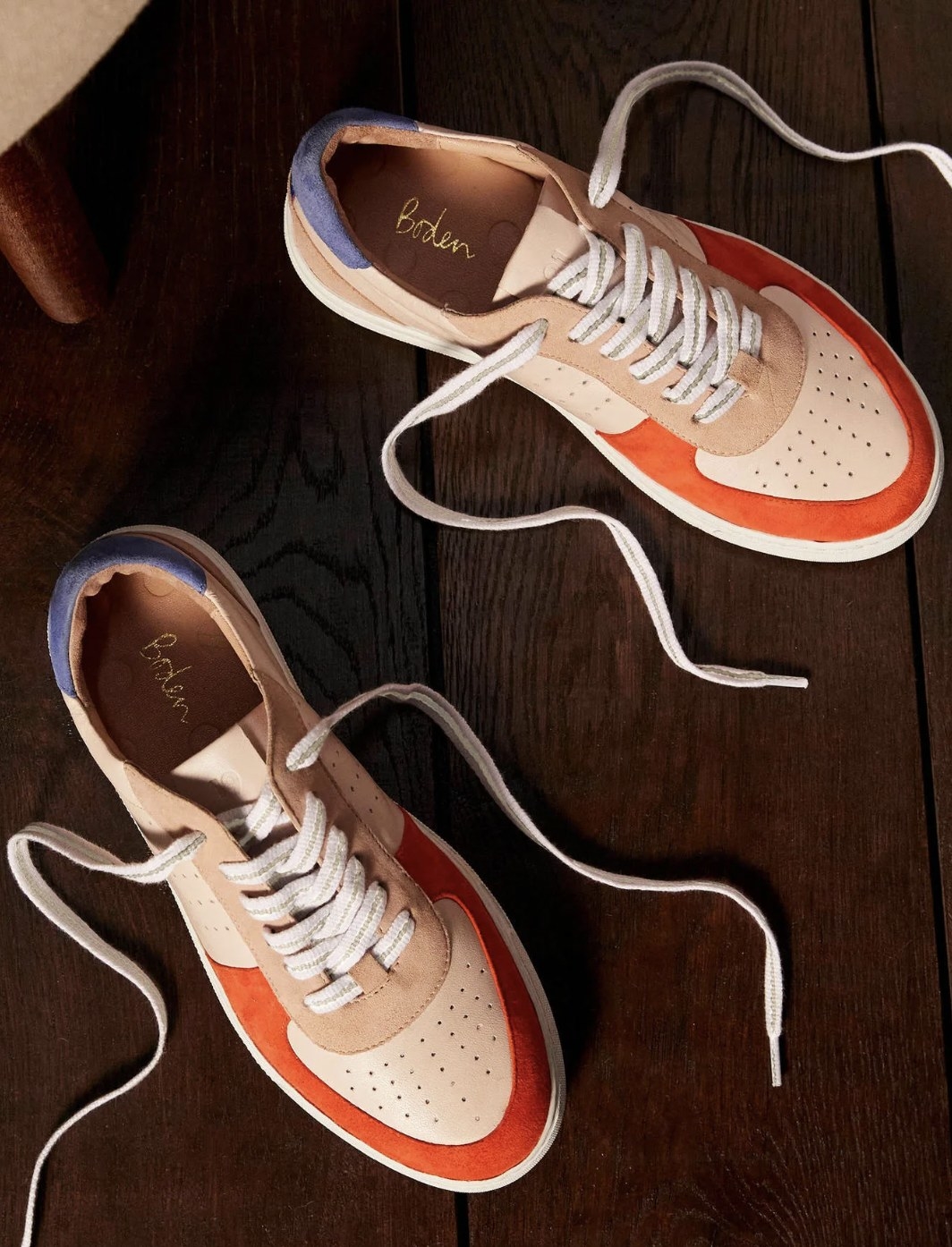 The tan sneakers with orange and purple colorblocks