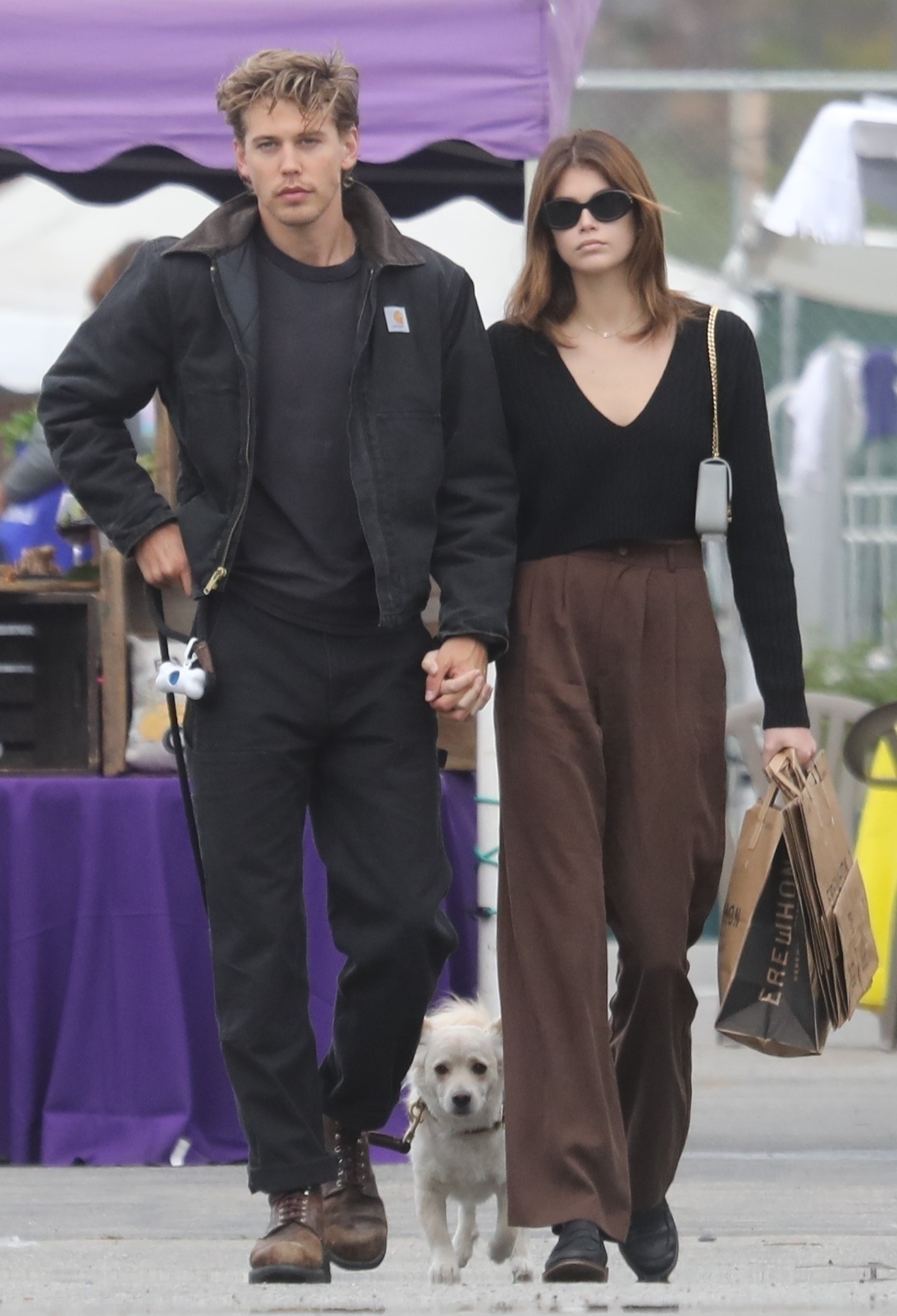austin butler and kaia gerber taking their dog for a walk