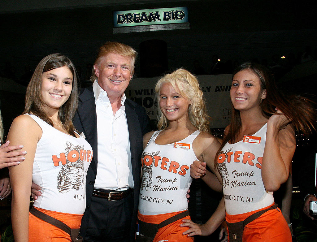 Donald Trump posing with Hooters girls.