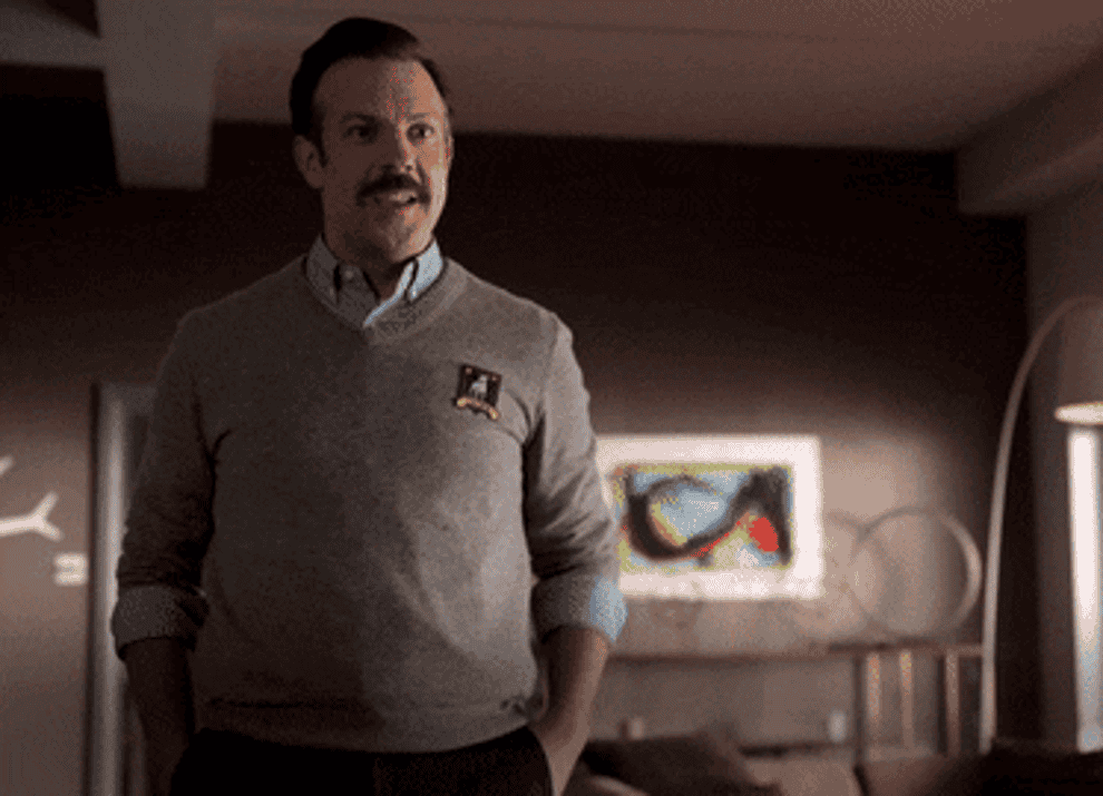 a gif of ted lasso jumping up and down and shouting MVP