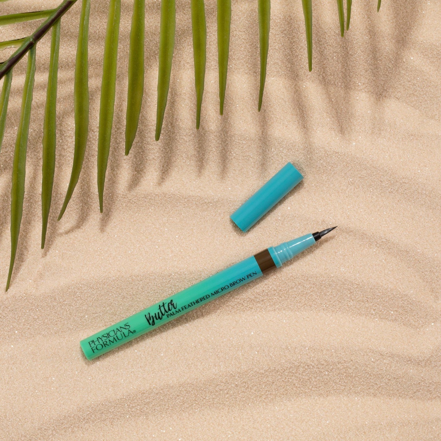 the brow pen laying in sand