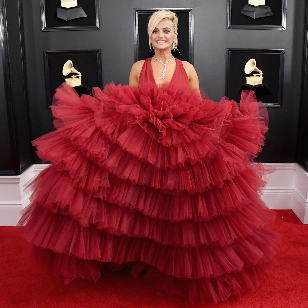 Bebe wearing a vibrant red dress with a huge, floofy red tulle