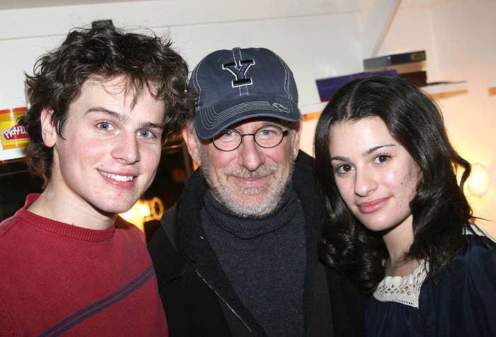 Jonathan Groff, Steven Spielberg, and Lea Michele stand together and smile