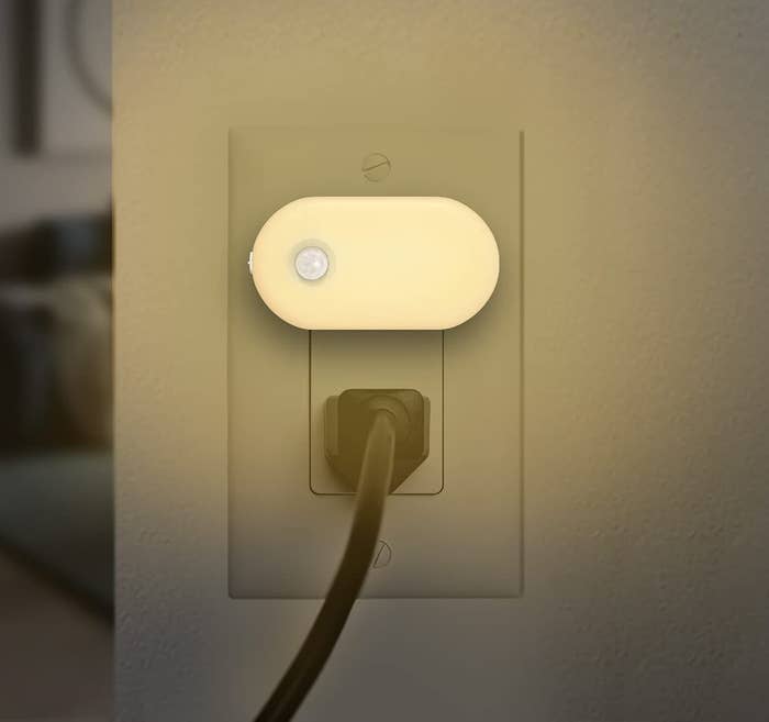 a motion-sensor night light plugged into an outlet