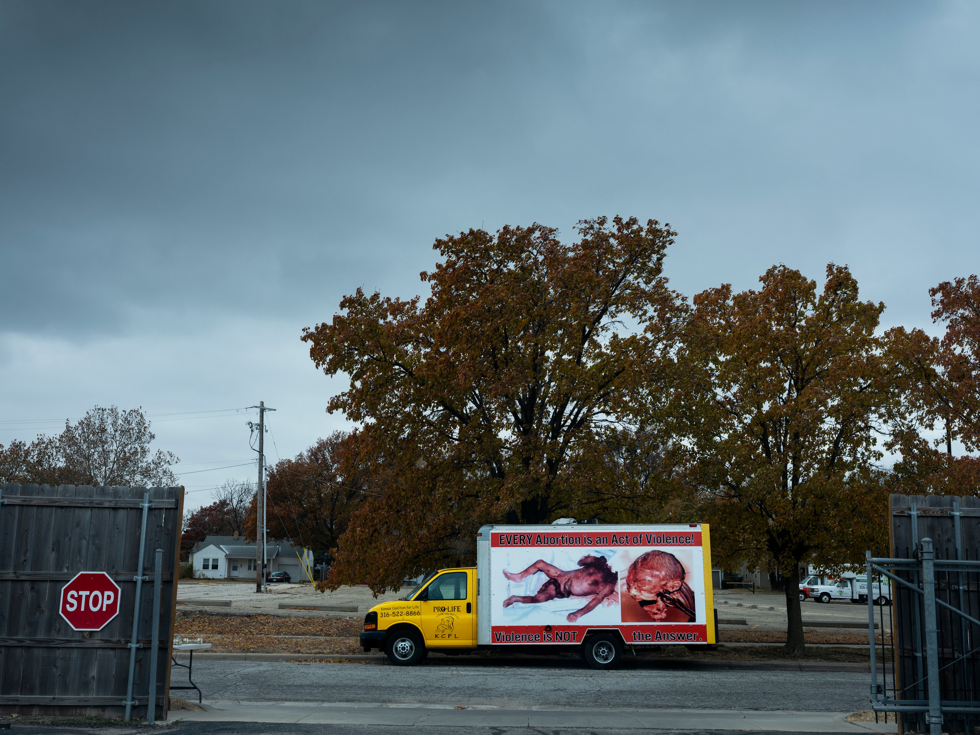 A truck with a large, graphic and misleading image of a nearly full term fetus with a sign saying every abortion is an act of violence sits on a street