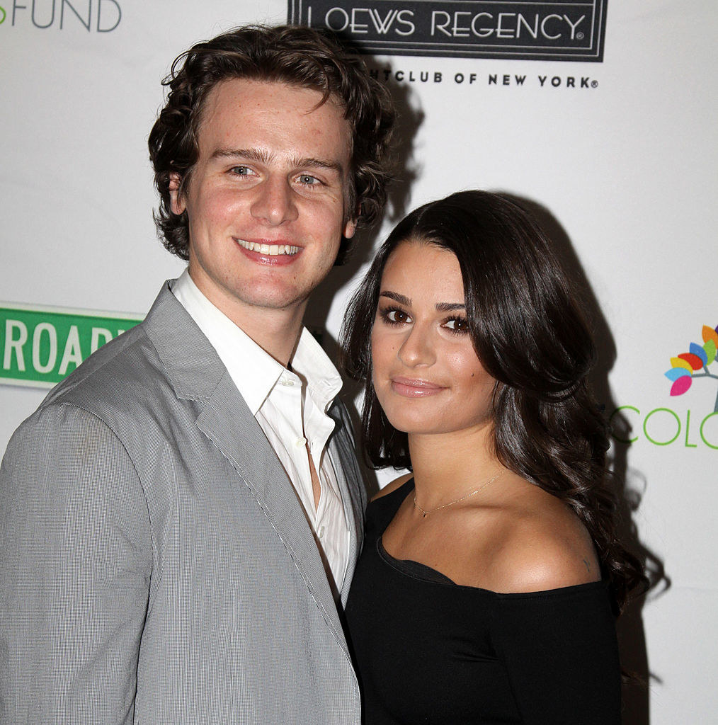 Jonathan Groff and Lea Michele smile and stand together