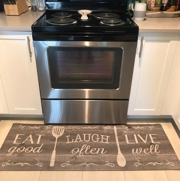 A reviewer&#x27;s image of a water-resistant anti-fatigue mat inside a kitchen area