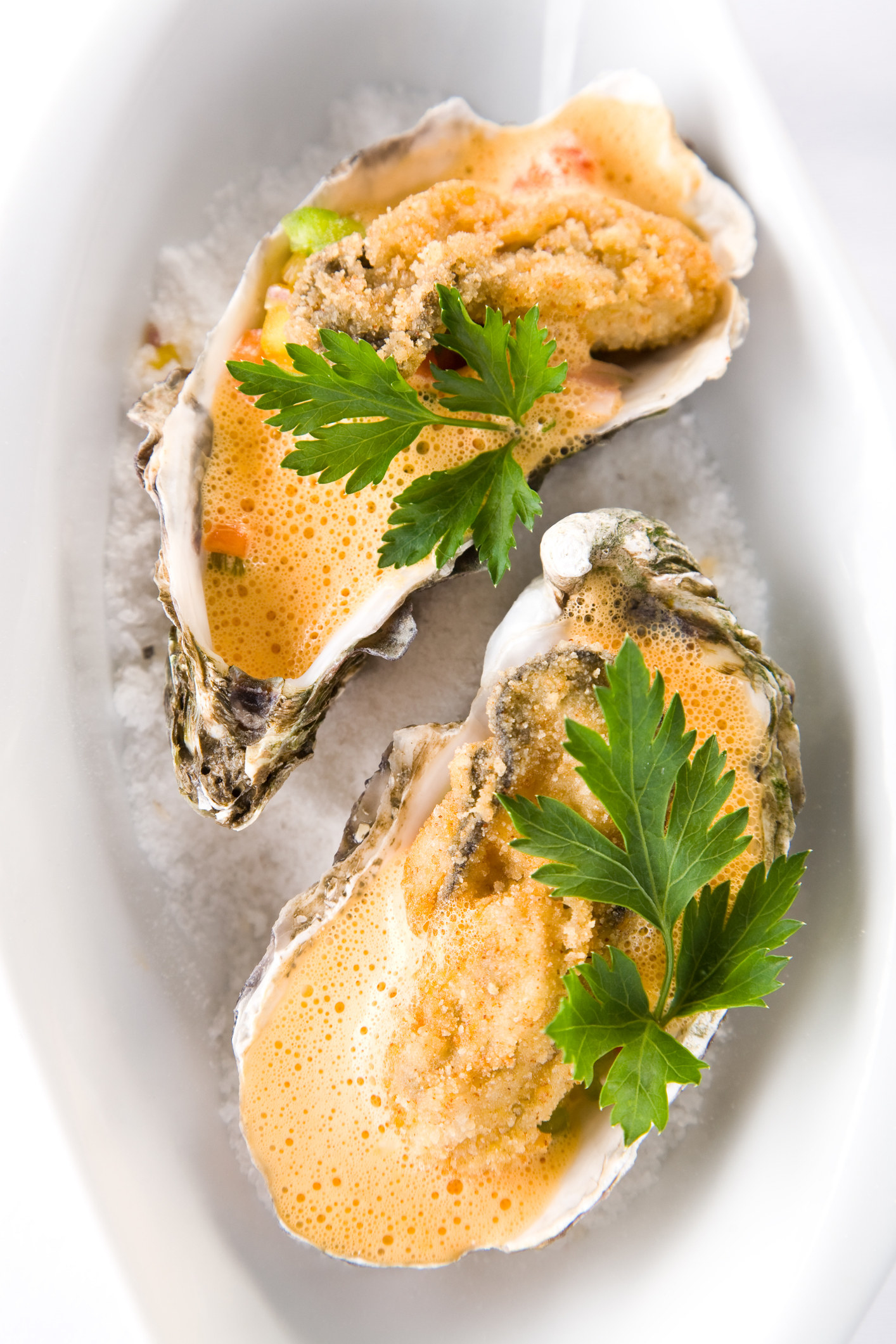Two fried oysters served in the shells.