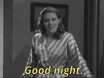 Kate McKinnon closing a door and saying goodnight