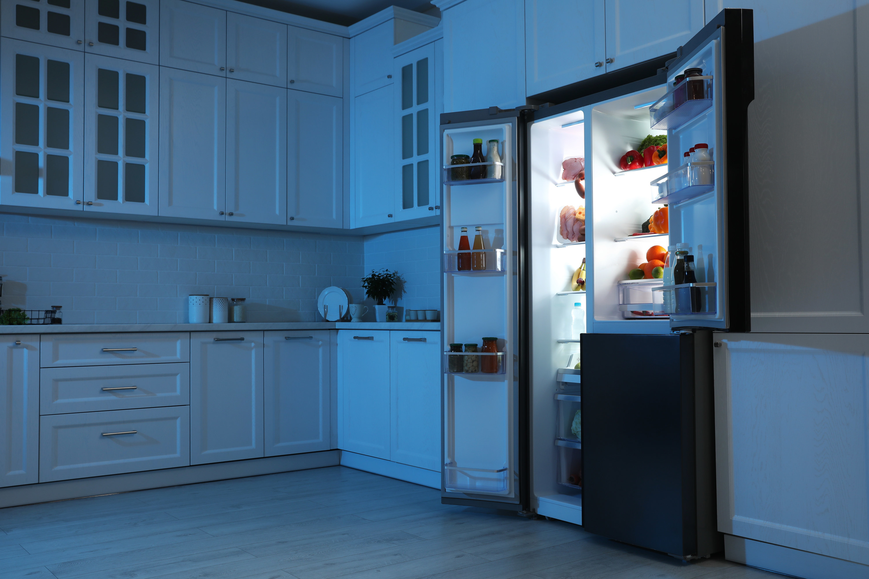 An open refrigerator, with items in the door shelves