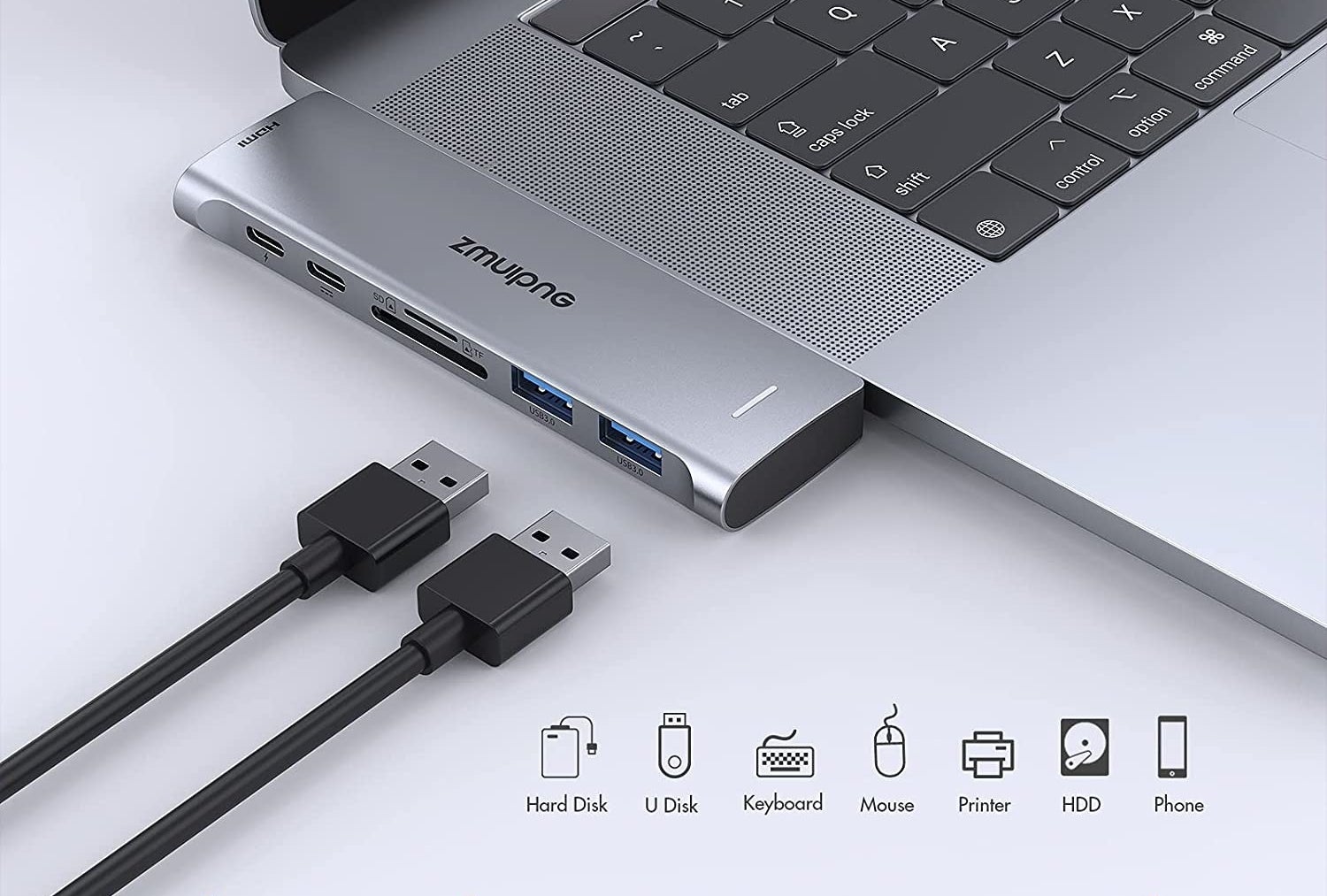 the adapter attached to a MacBook with usb cords next to it