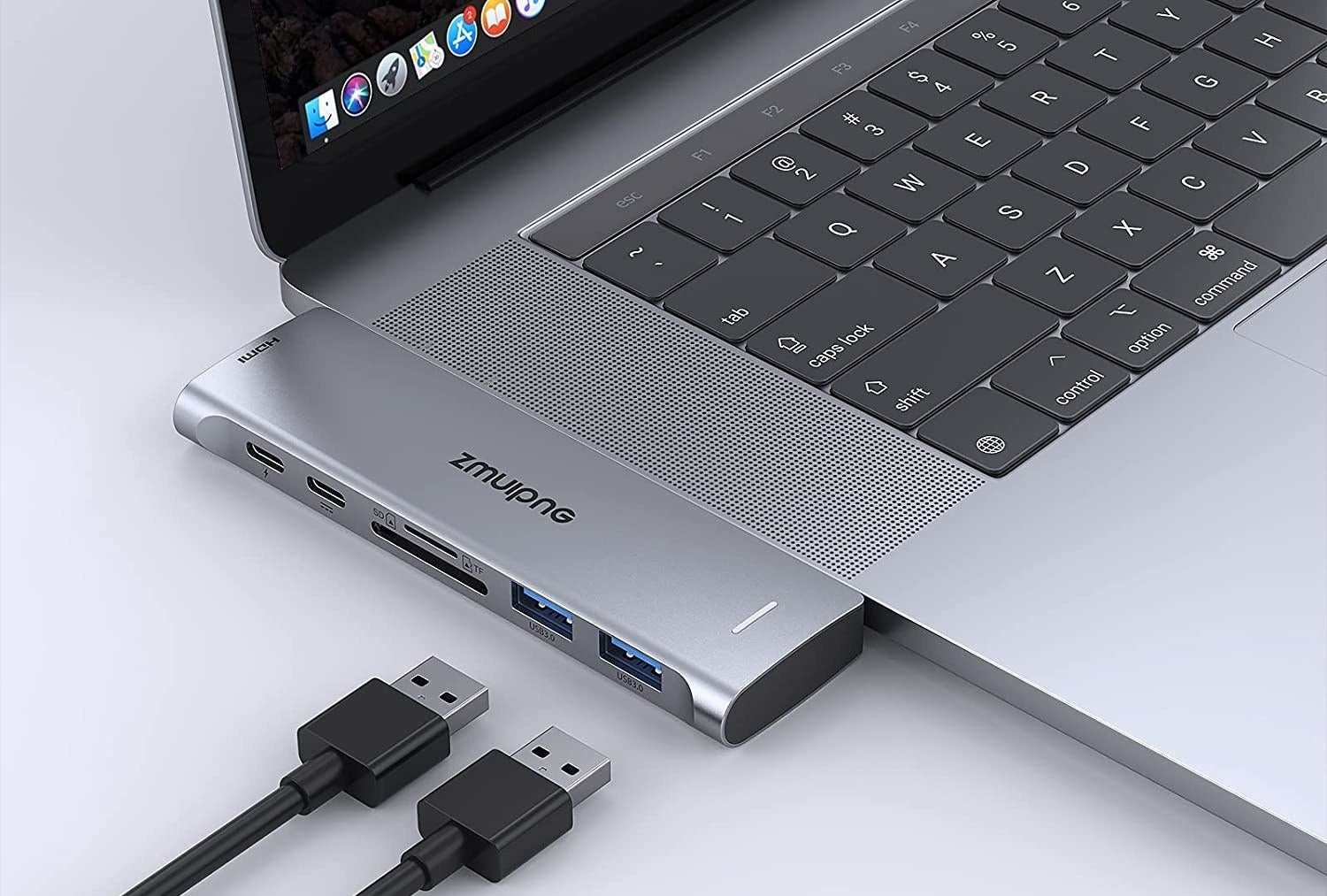 the adapter attached to a MacBook with usb cords next to it