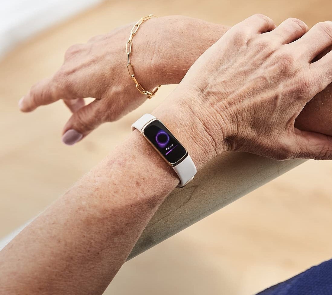 A person&#x27;s arms with the fitbit on