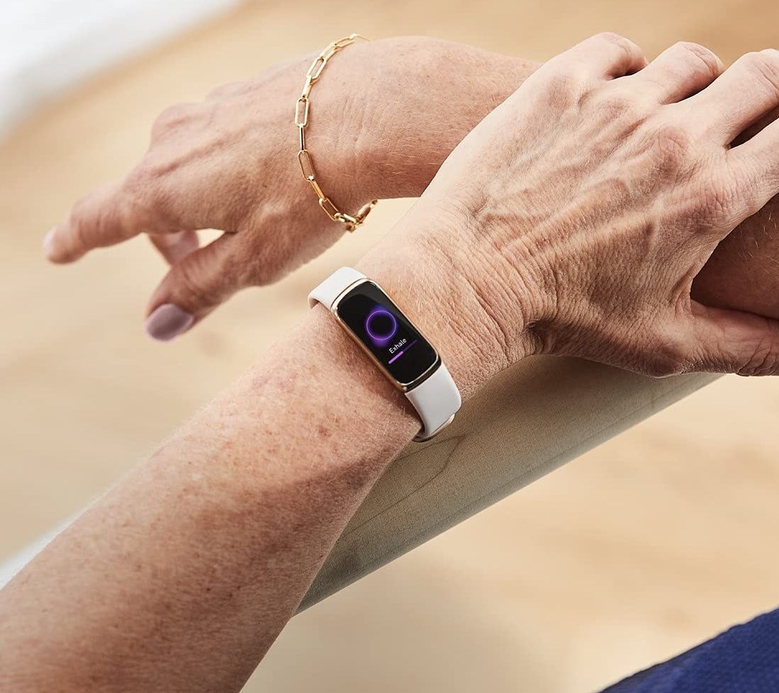 A person's arms with the fitbit on