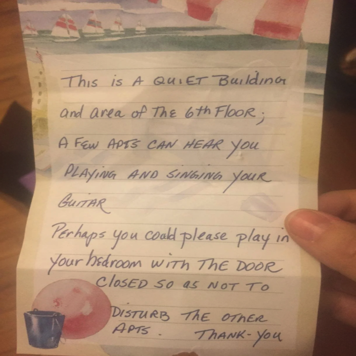 A handwritten note from a neighbour complaining about how loud someone's guitar playing is