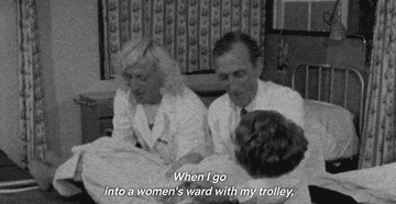 A GIF of Jimmy Savile shows him helping a woman onto another bed with assistance