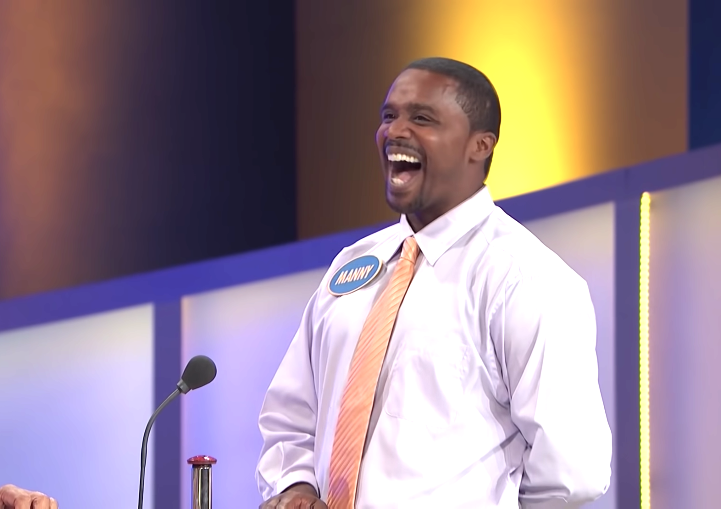 a man laughing on a game show