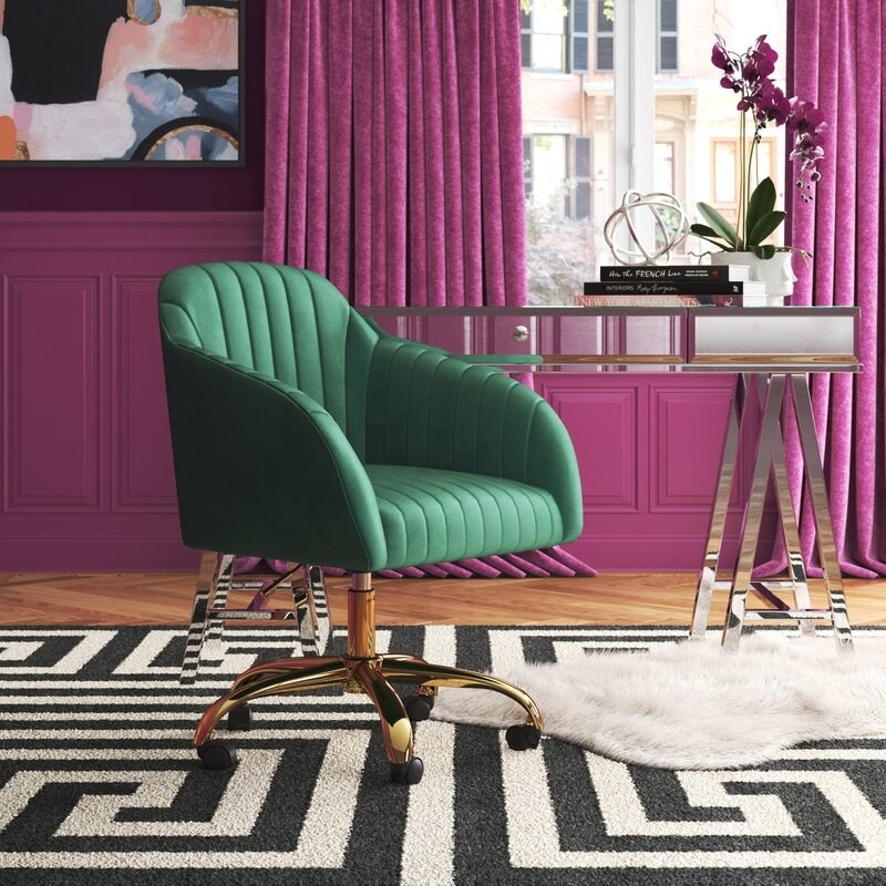 the Adan Task Chair in green styled in an office with pink walls