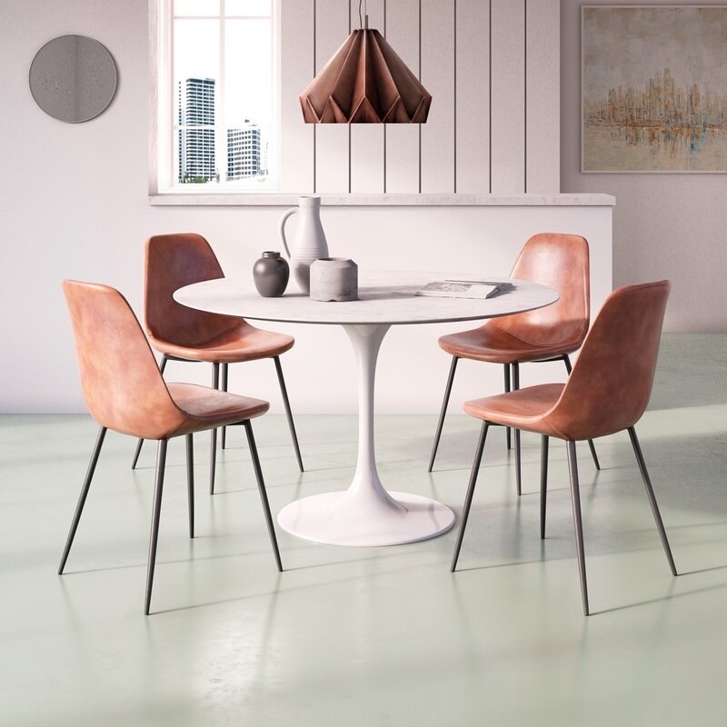 four of the dining chairs around a tulip-style dining table