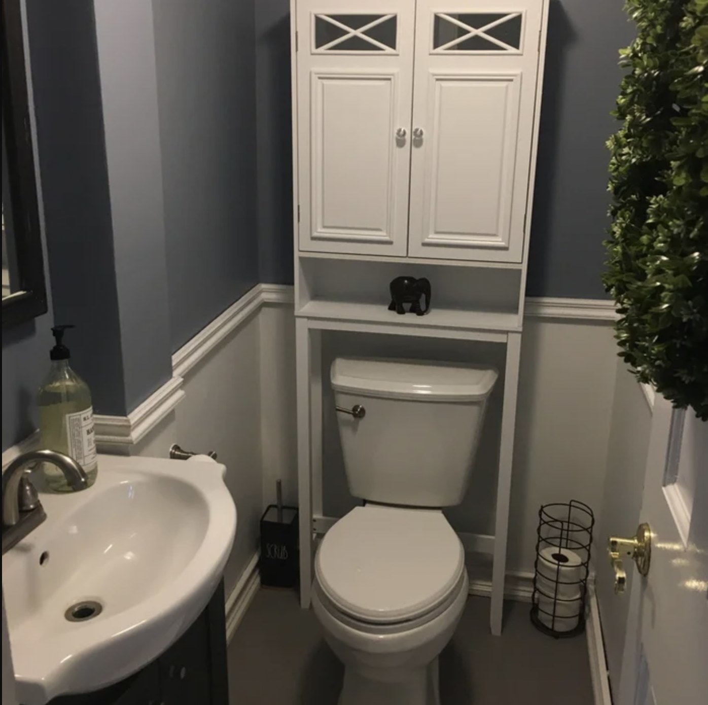 reviewer&#x27;s photo of the white storage unit installed over the toilet