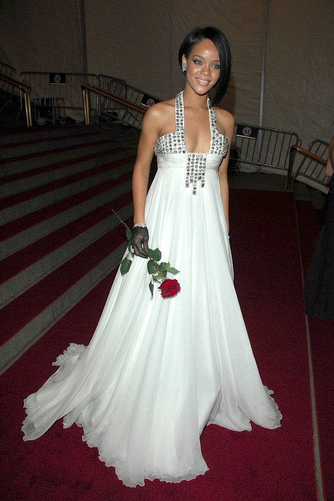 Rihanna rocked an asymmetrical bob and wore a floor-length flow-y gown and carried a rose