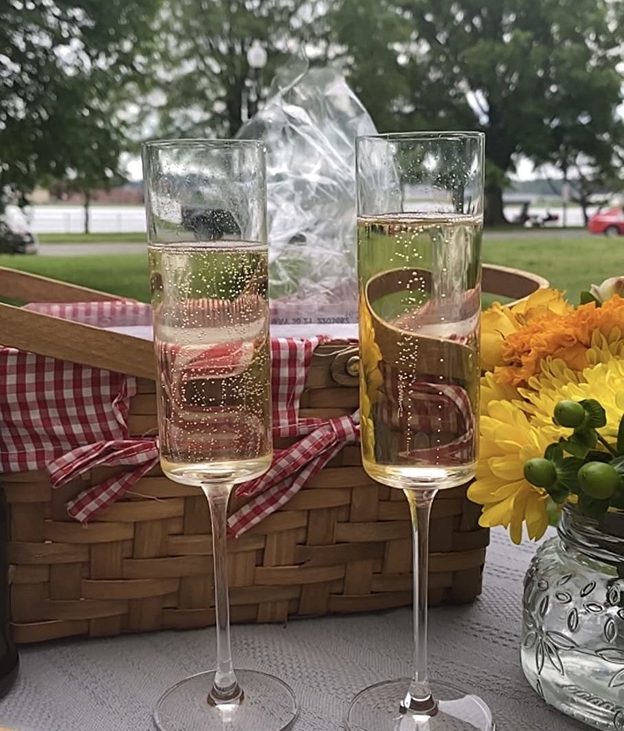 a reviewer photo of the two flutes filled with champagne on a picnic