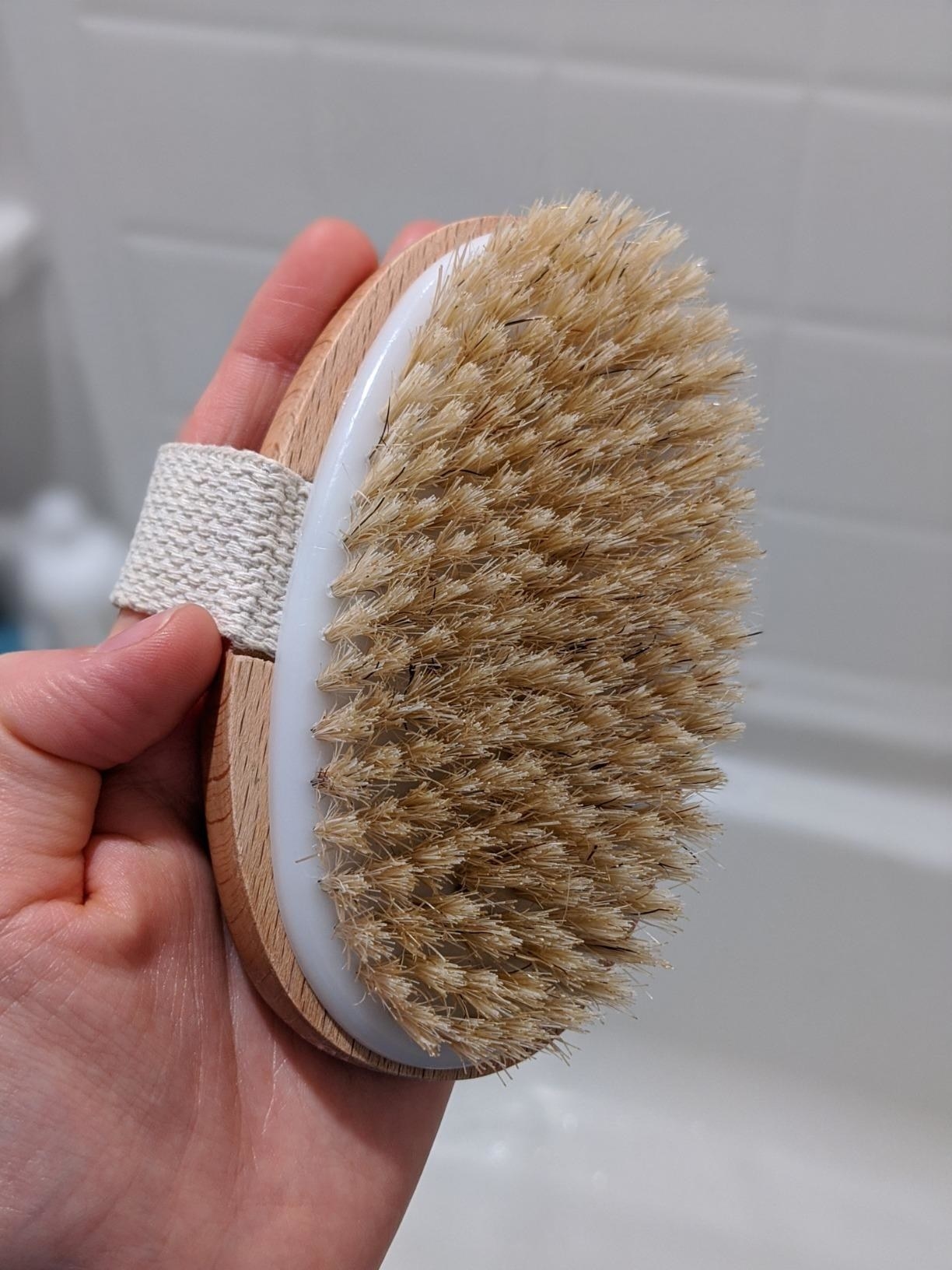 a person holding their dry brush