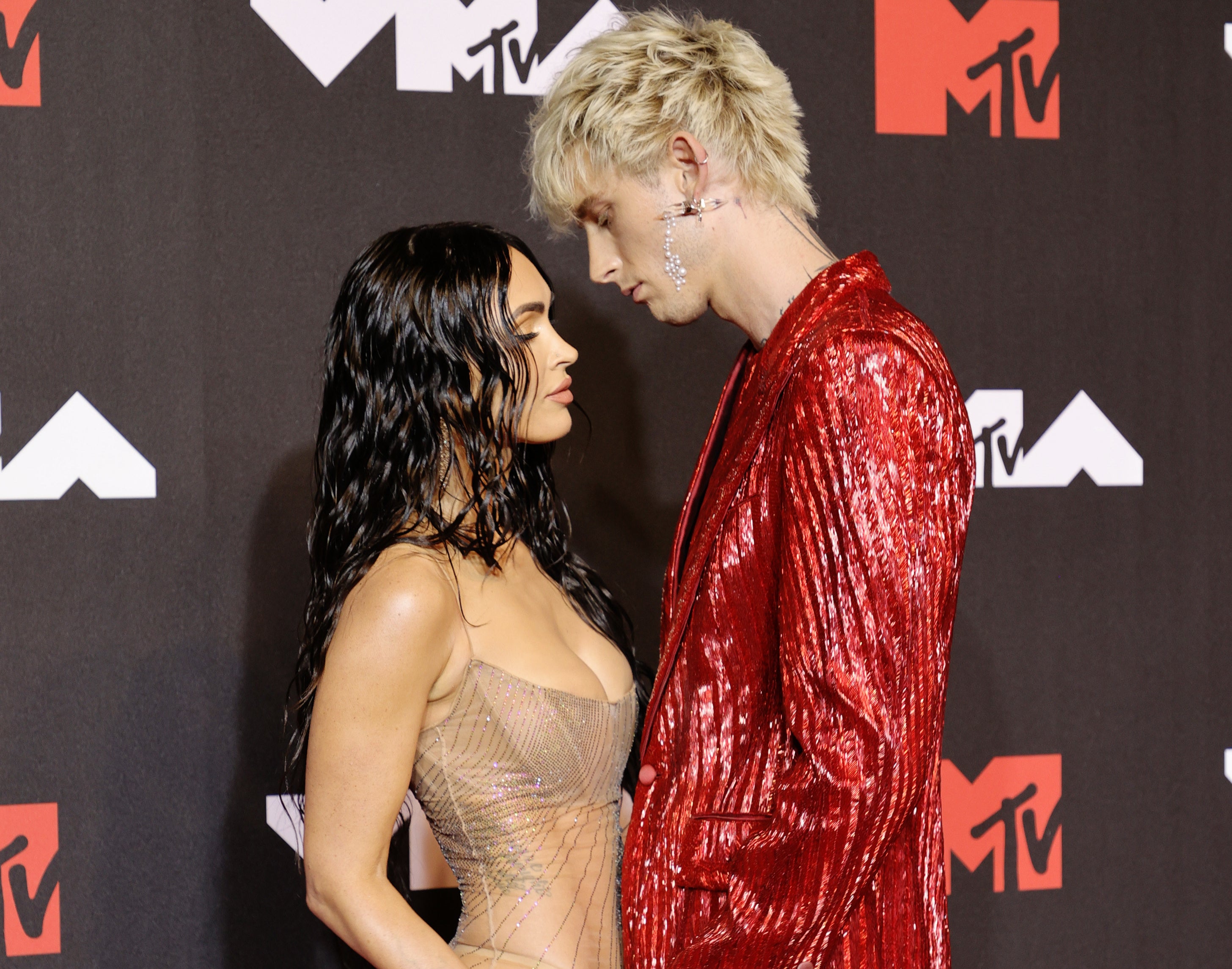 A closeup of Megan and Machine Gun Kelly staring into each other&#x27;s eyes
