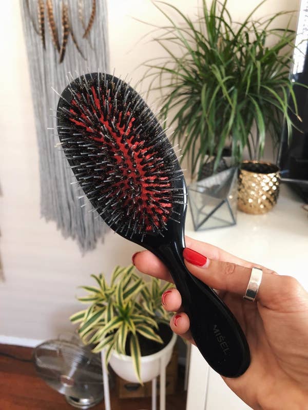 a reviewer photo of a hand holding the brush