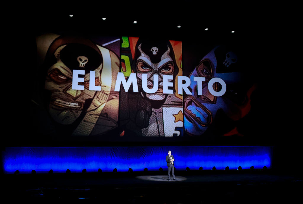 A CinemaCon presentation in front of a giant colorful screen that says &quot;El Muerto&quot;