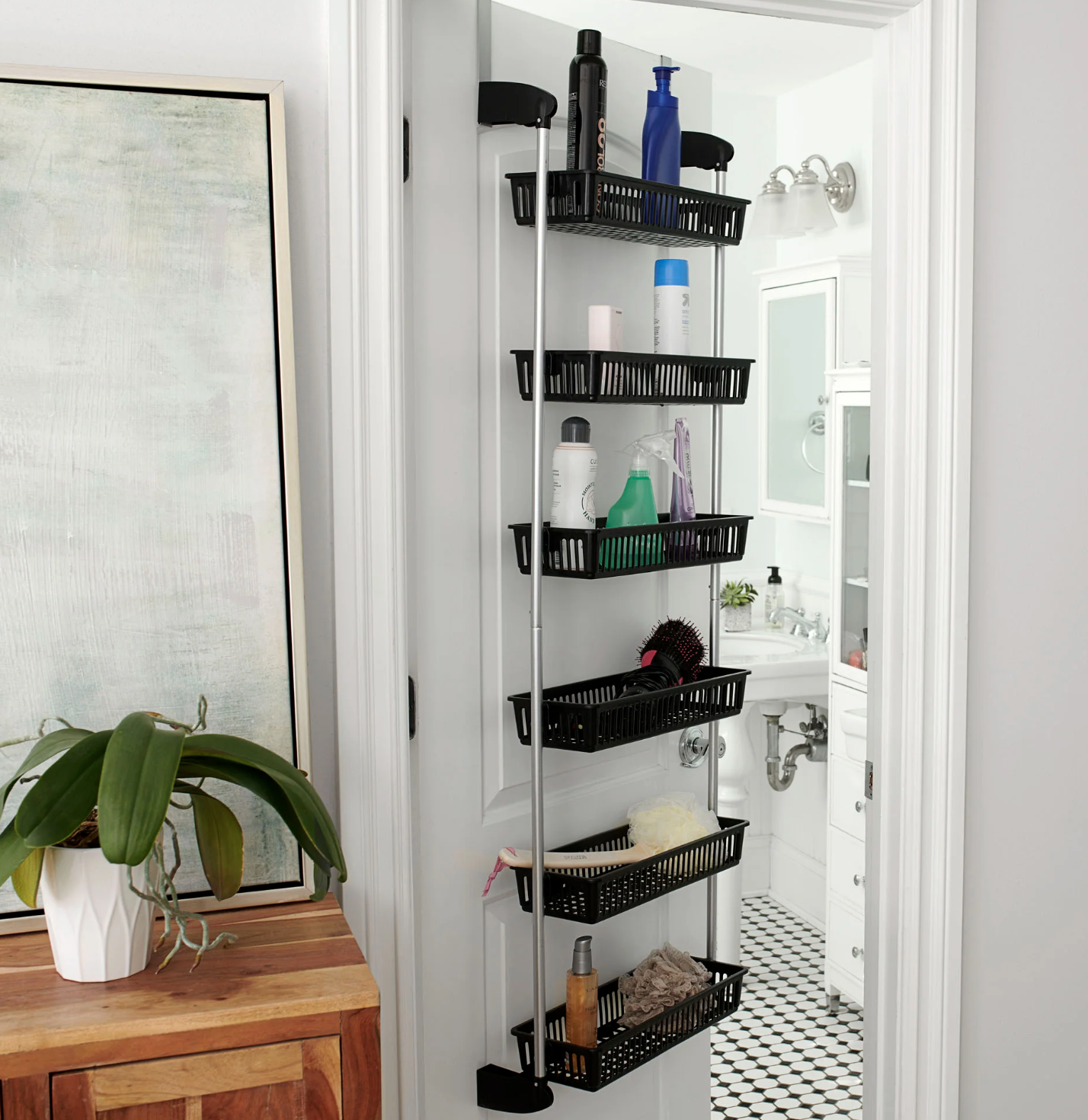 The organizer on a bathroom door with products in each basket