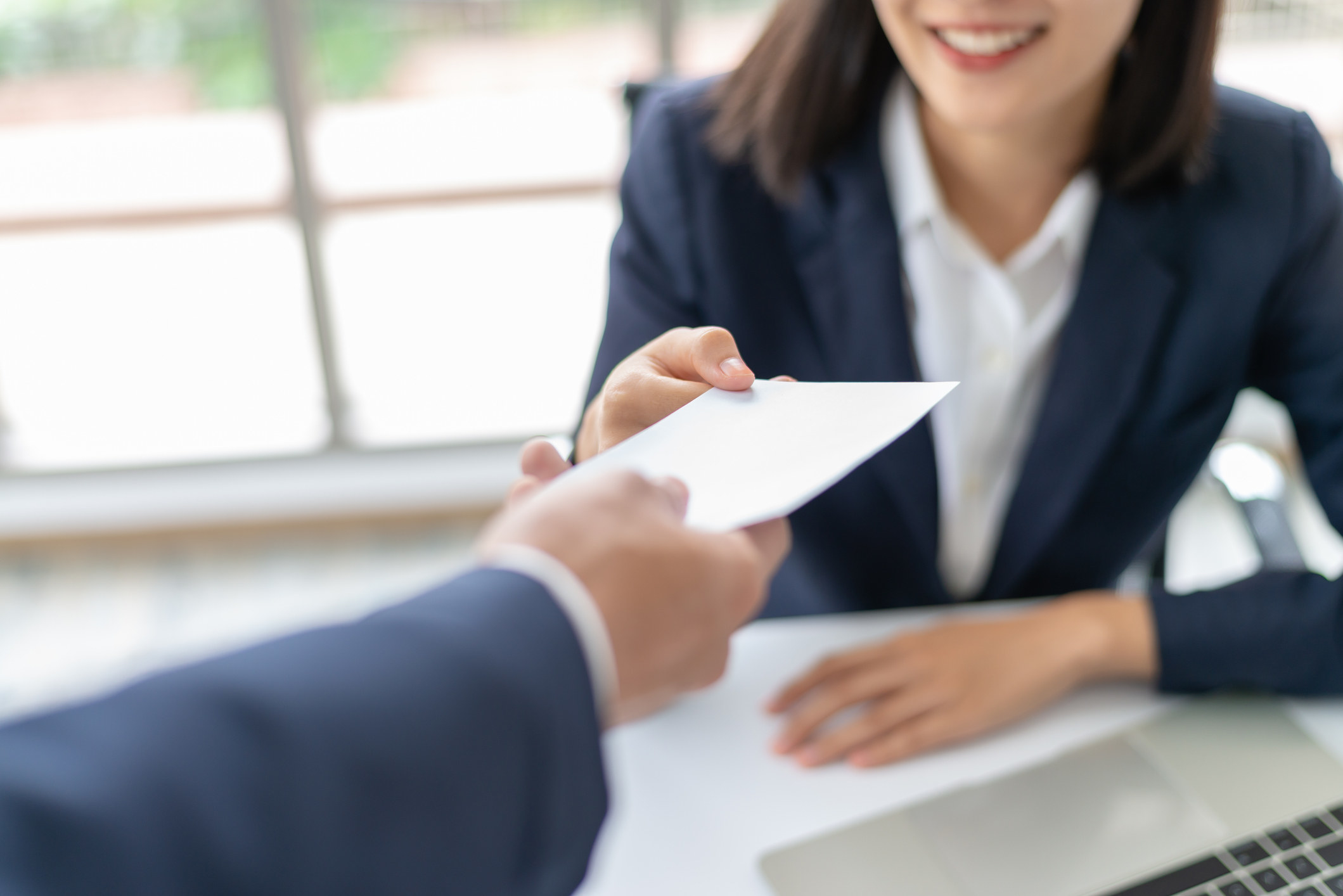 a person handing over a check