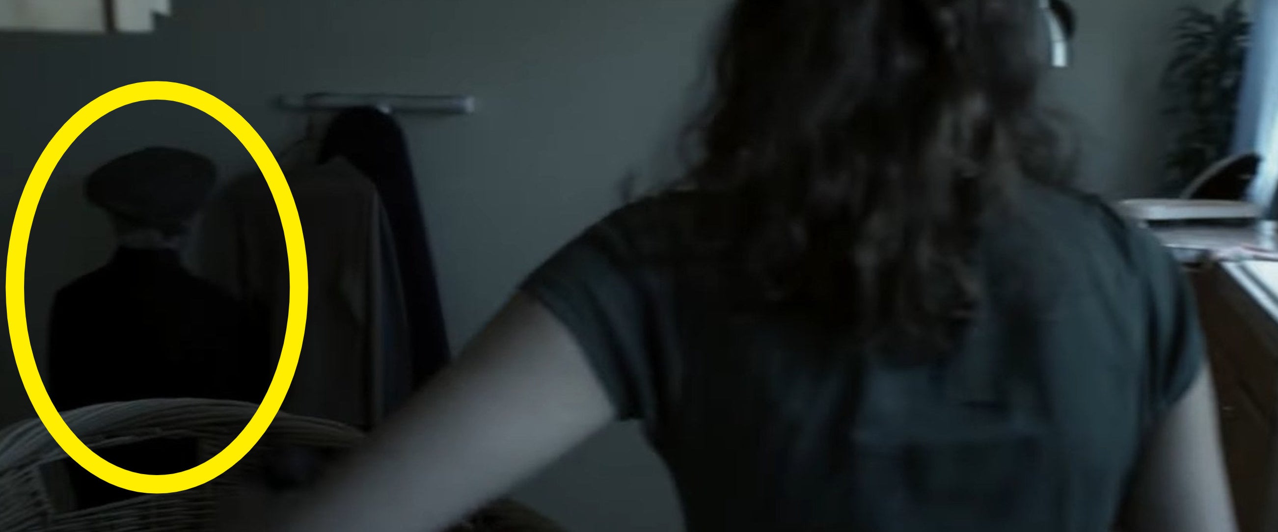 Renai putting laundry into a basket in &quot;Insidious&quot;