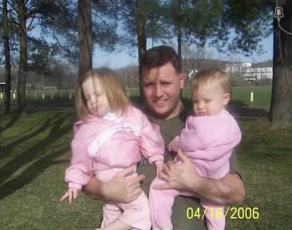 J.J. holding his daughters when they were toddlers