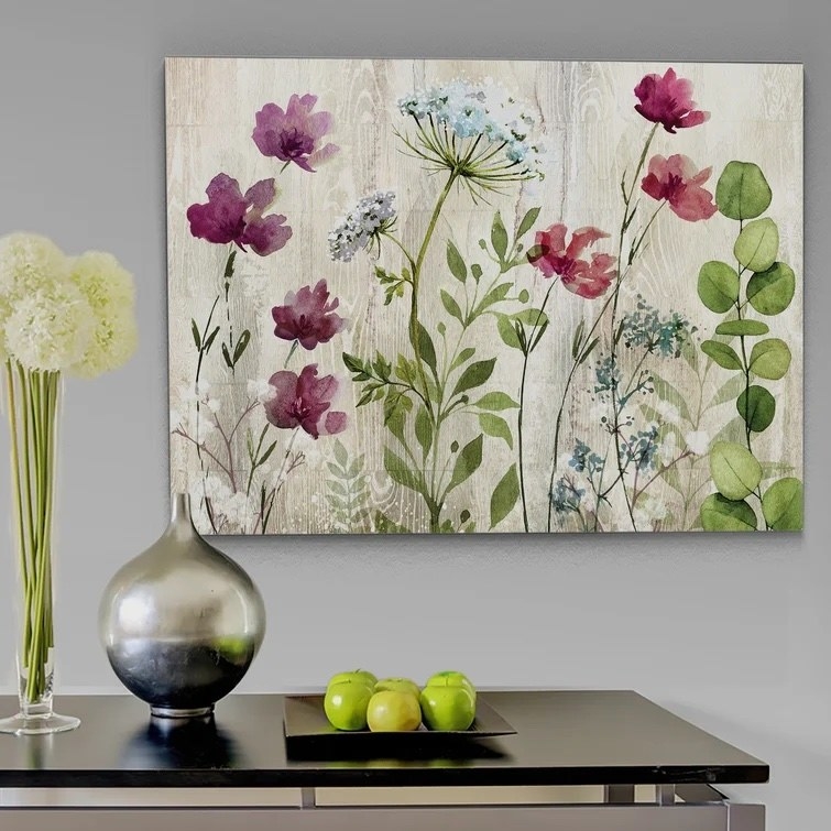 The canvas hanging above a table in a dining room
