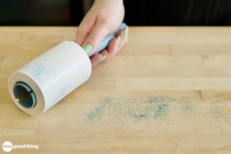 Blogger&#x27;s photo of a hand passing a lint roller over glitter