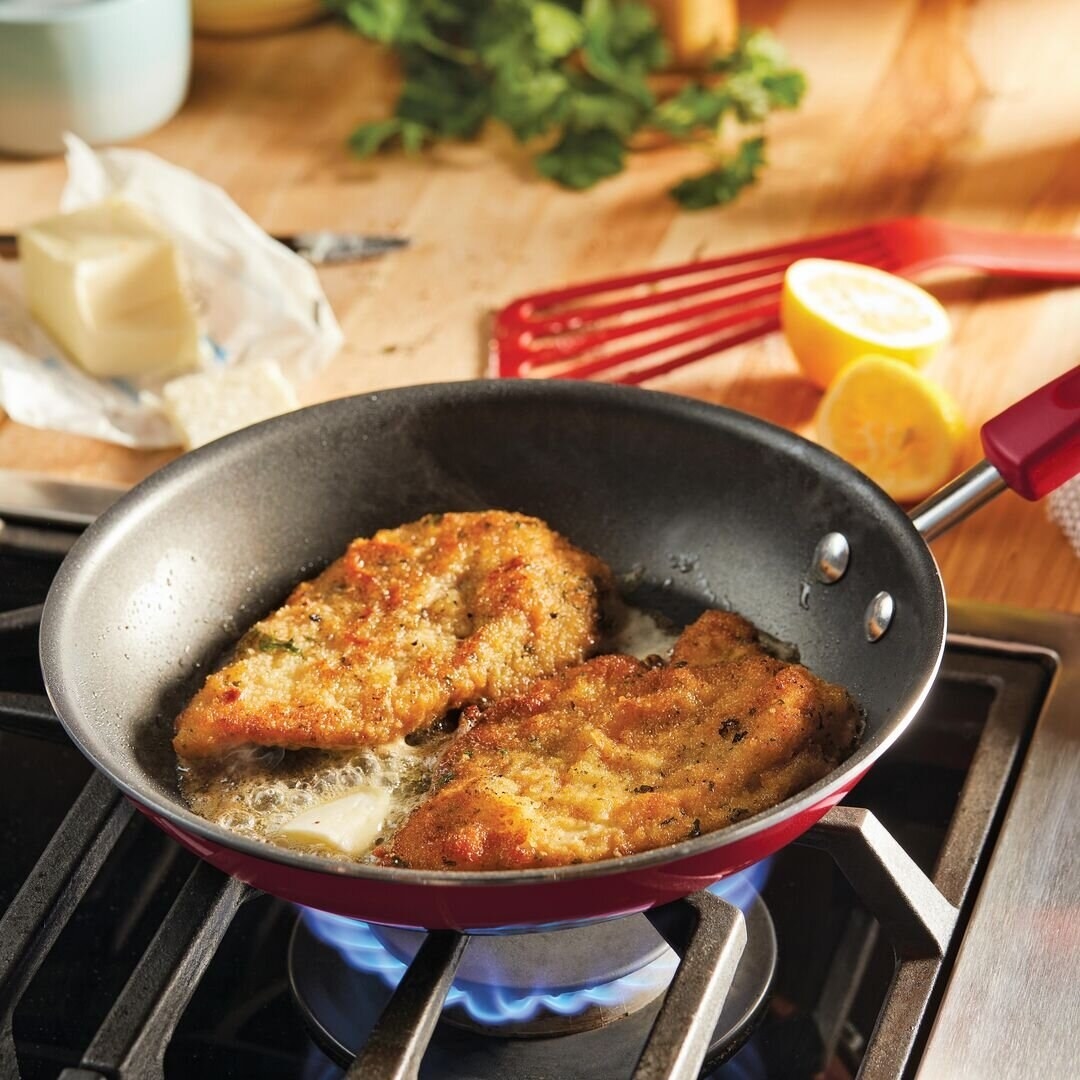 the skillet in red cooking schnitzel