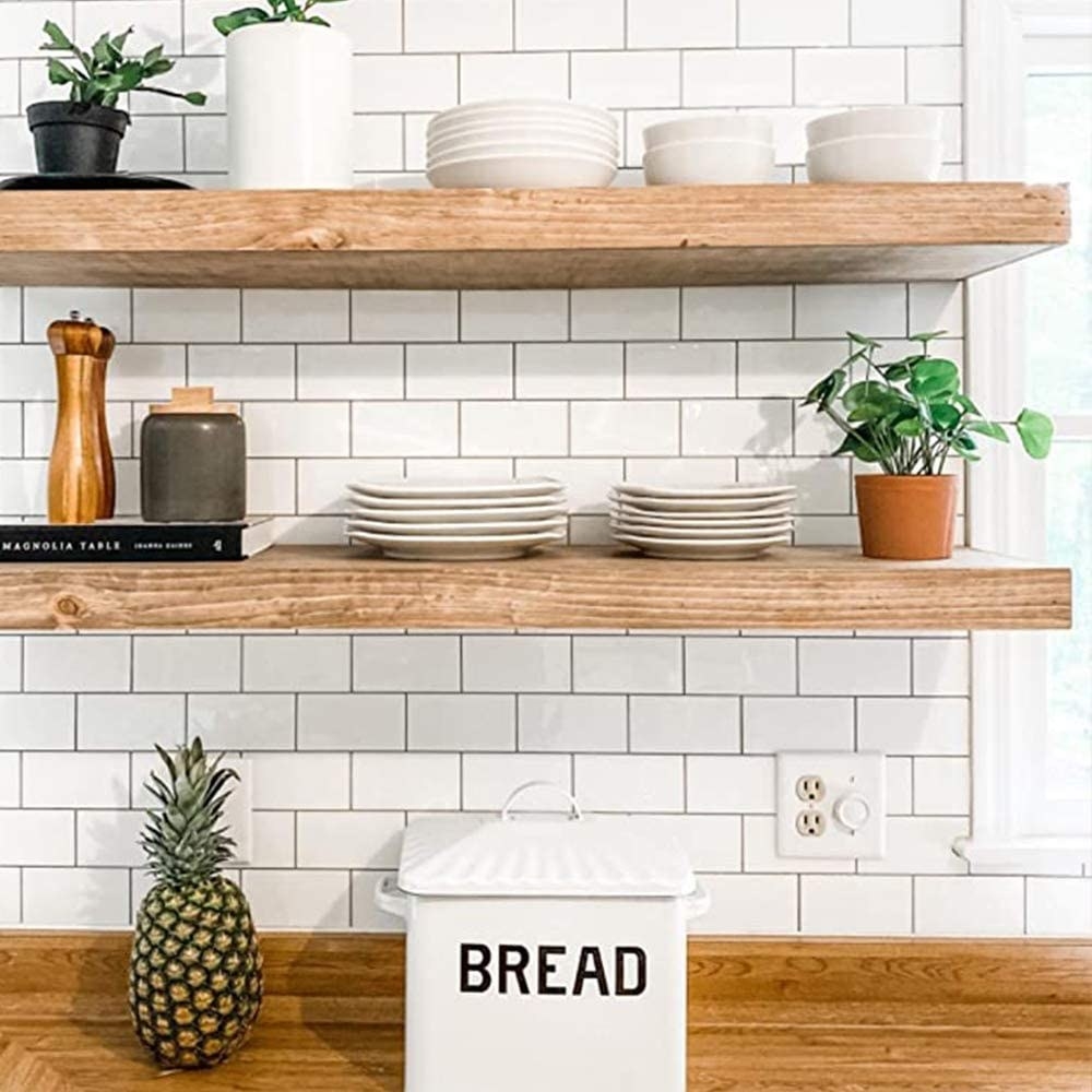 the peel and stick on a kitchen backsplash with shelves and plates