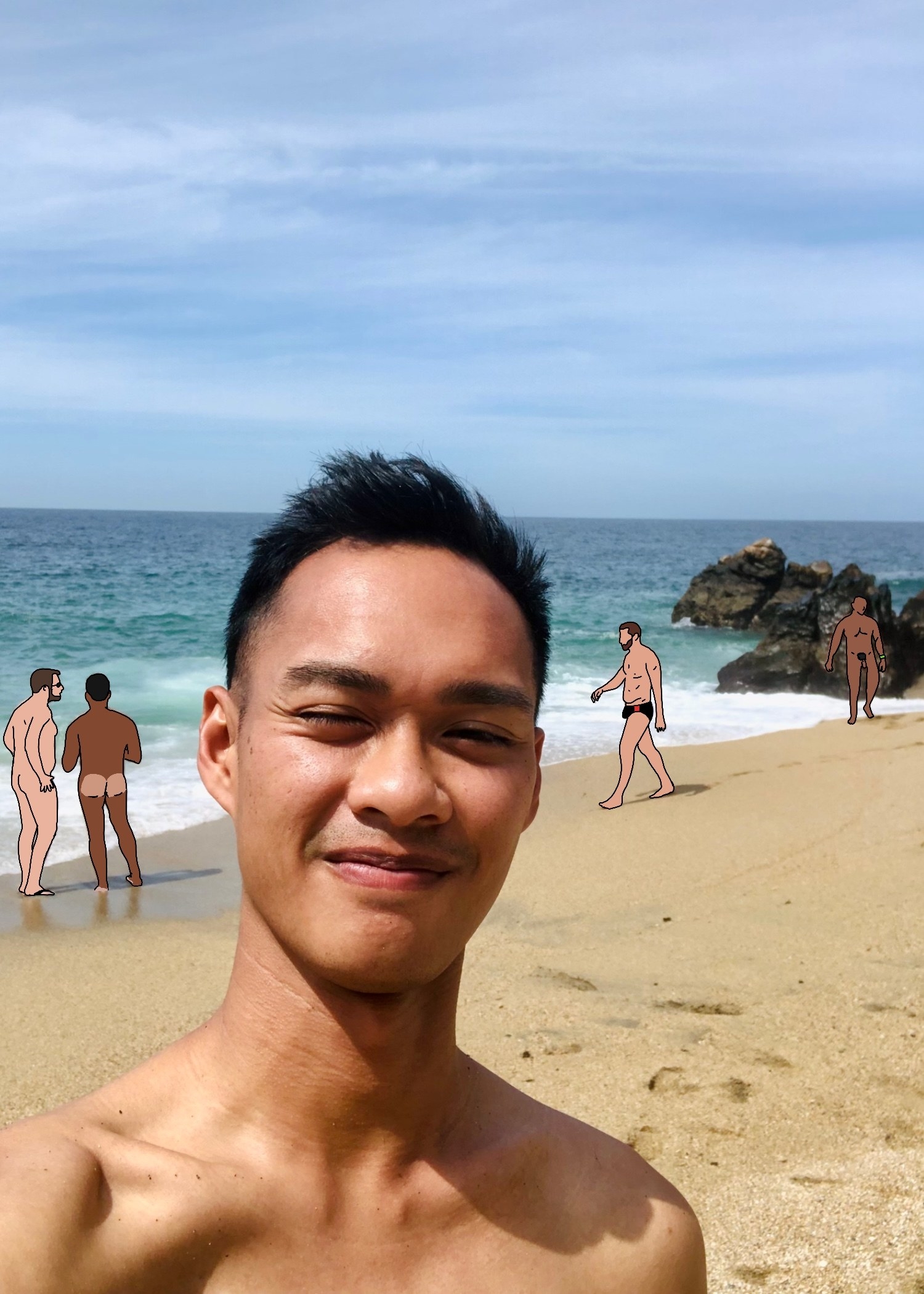 author with naked men in the background on the beach