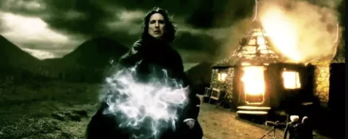 Snape standing in front of Hagrid&#x27;s Hut, which is on fire, casting a spell