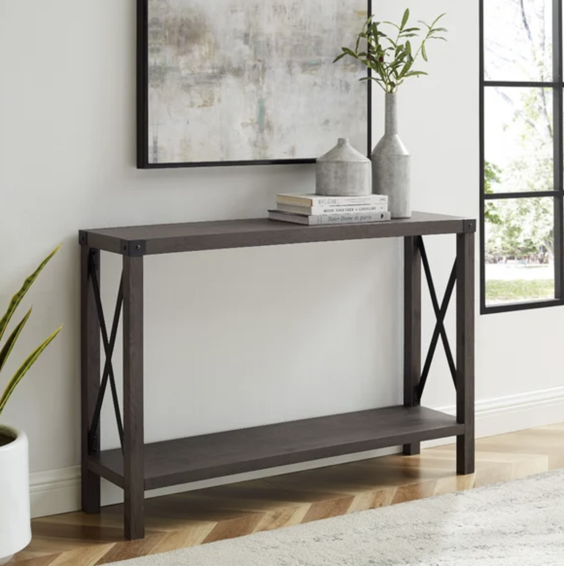 The console table in a room with a plant on top of it