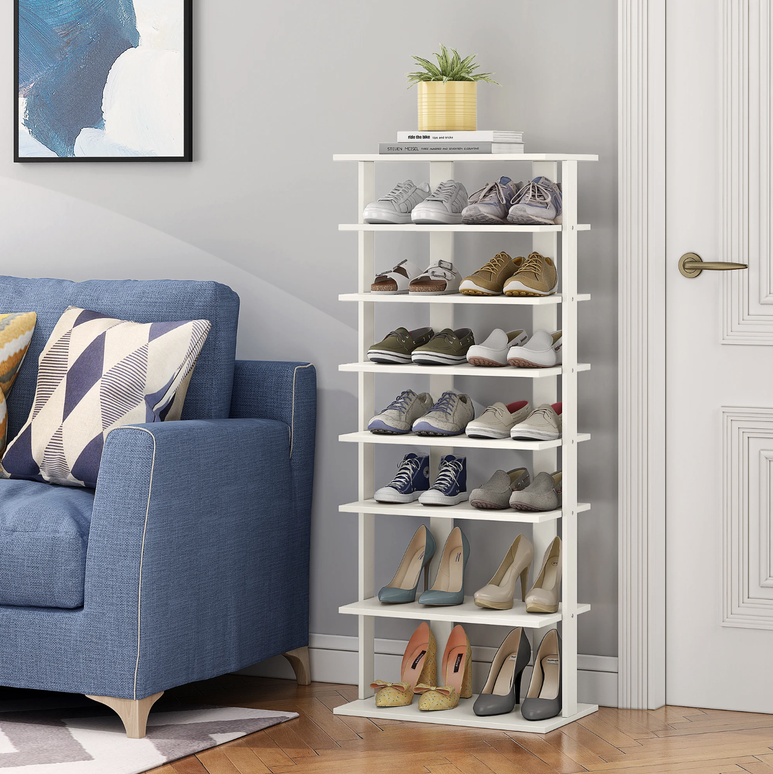 The filled shoe rack next to a couch