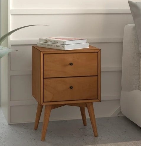 The nightstand in a room beside a plant