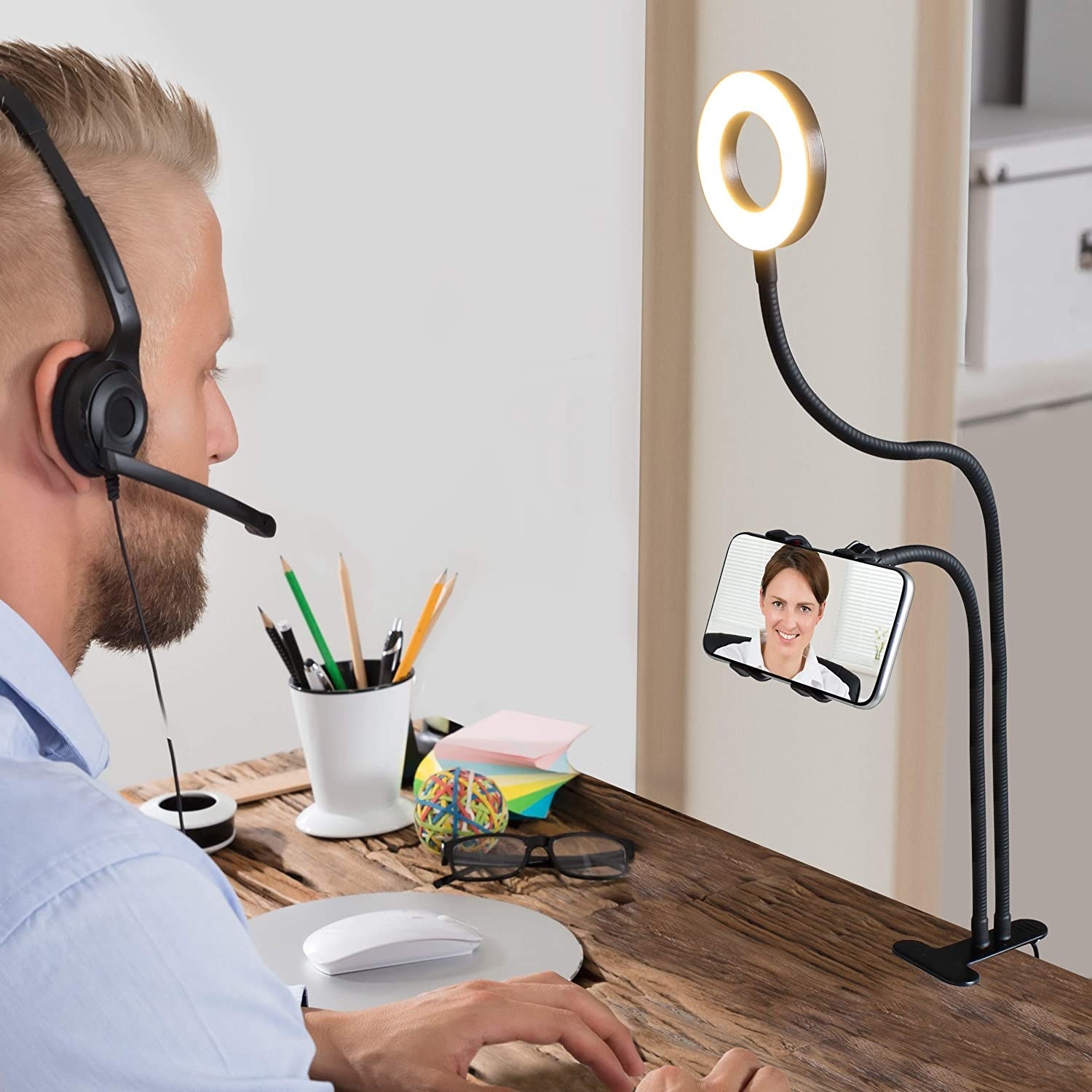 a person using the ring light phone holder at a desk