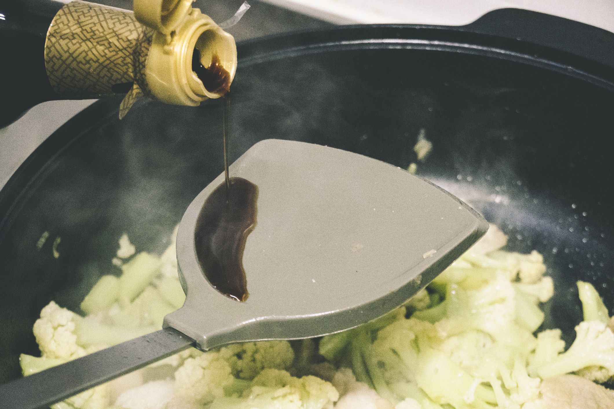Adding soy sauce to a skillet