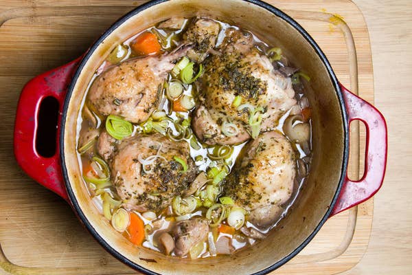 A Dutch oven containing chicken and vegetables