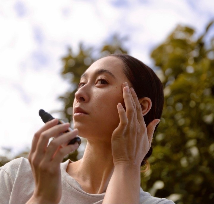 a person applying the serum to their face